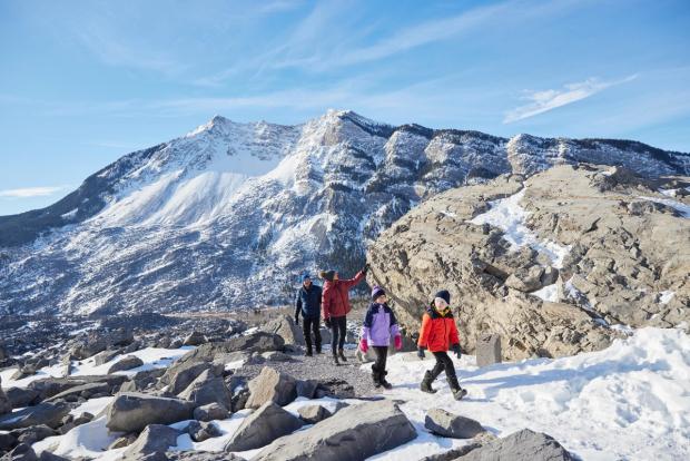 A family hiking and exploring at Frank Slide in the Crowsnest Pass.