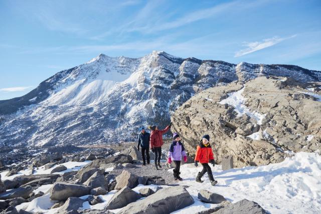 A family hiking and exploring at Frank Slide in the Crowsnest Pass.