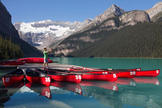 Red canoes at the dock on the lake at the Fairmont Chateau Lake Louise.