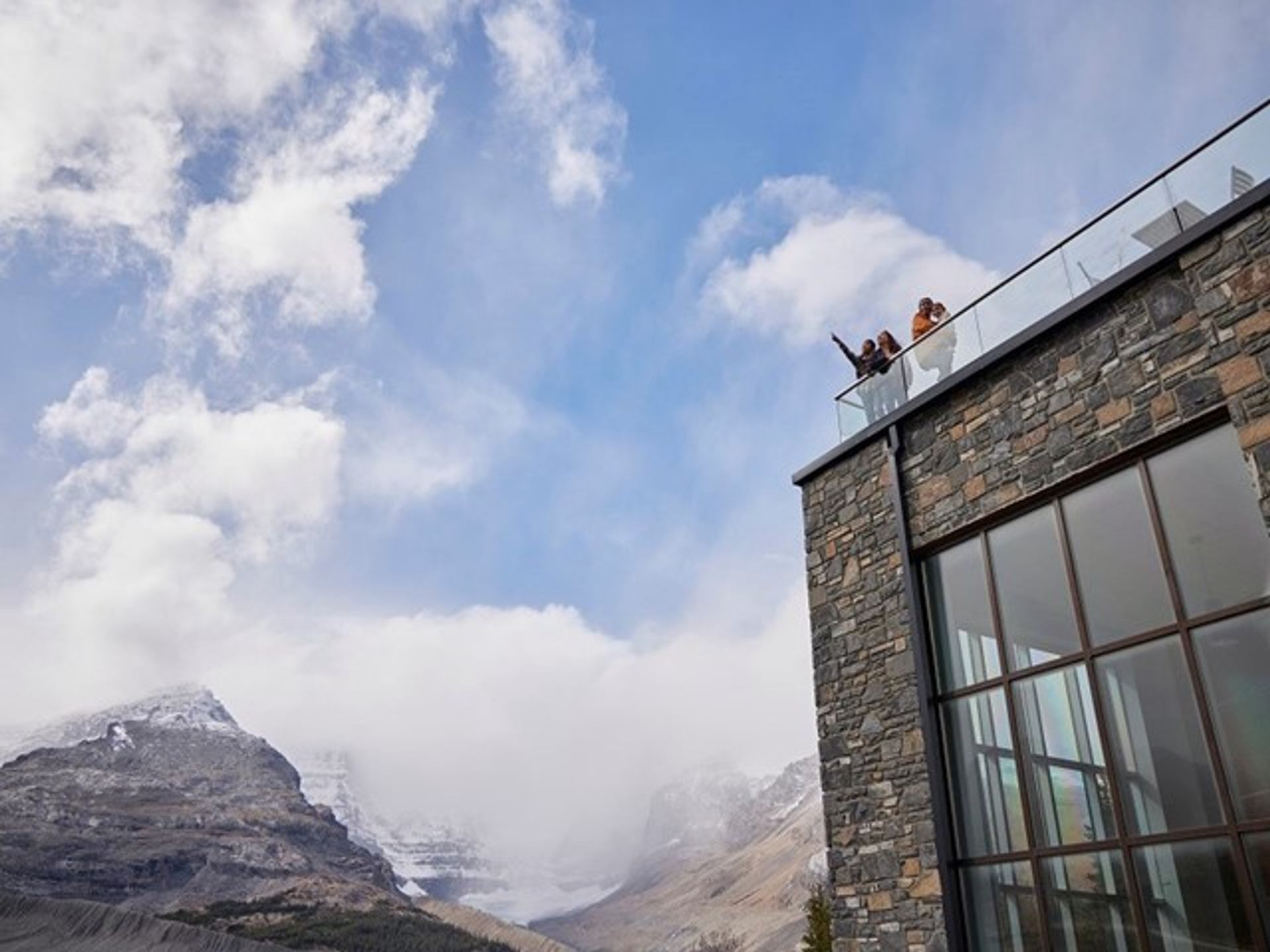 Family looking at the view from the Columbia Icefield Discovery Centre building.