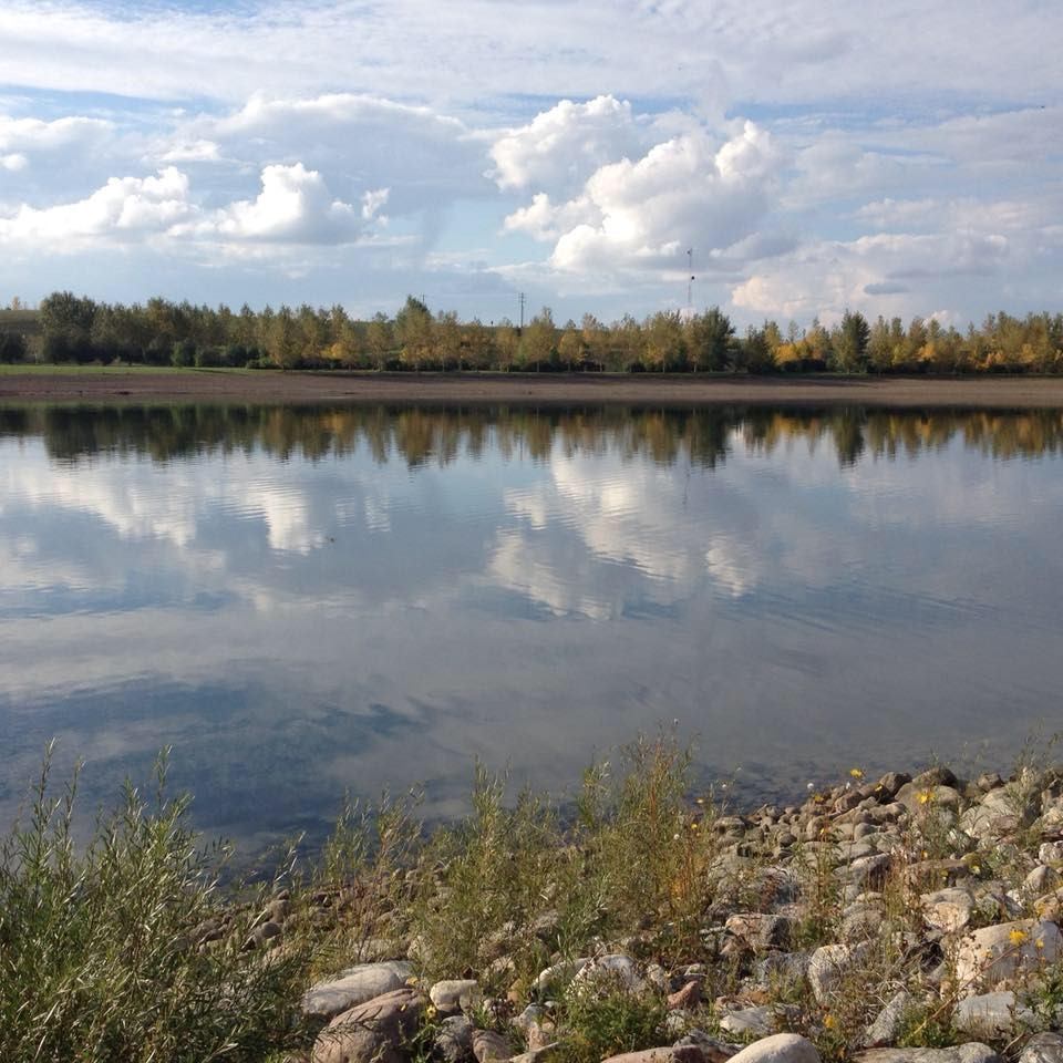 Calm lake with the refection of the trees in it.