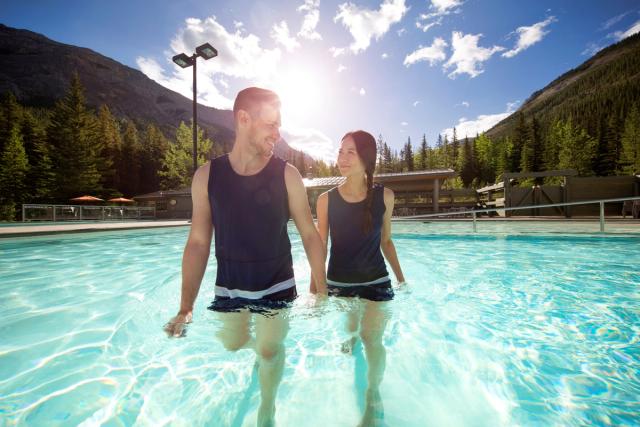 Guest wearing traditional rental bathing suit enjoying a soak at the Miette Hot Springs.