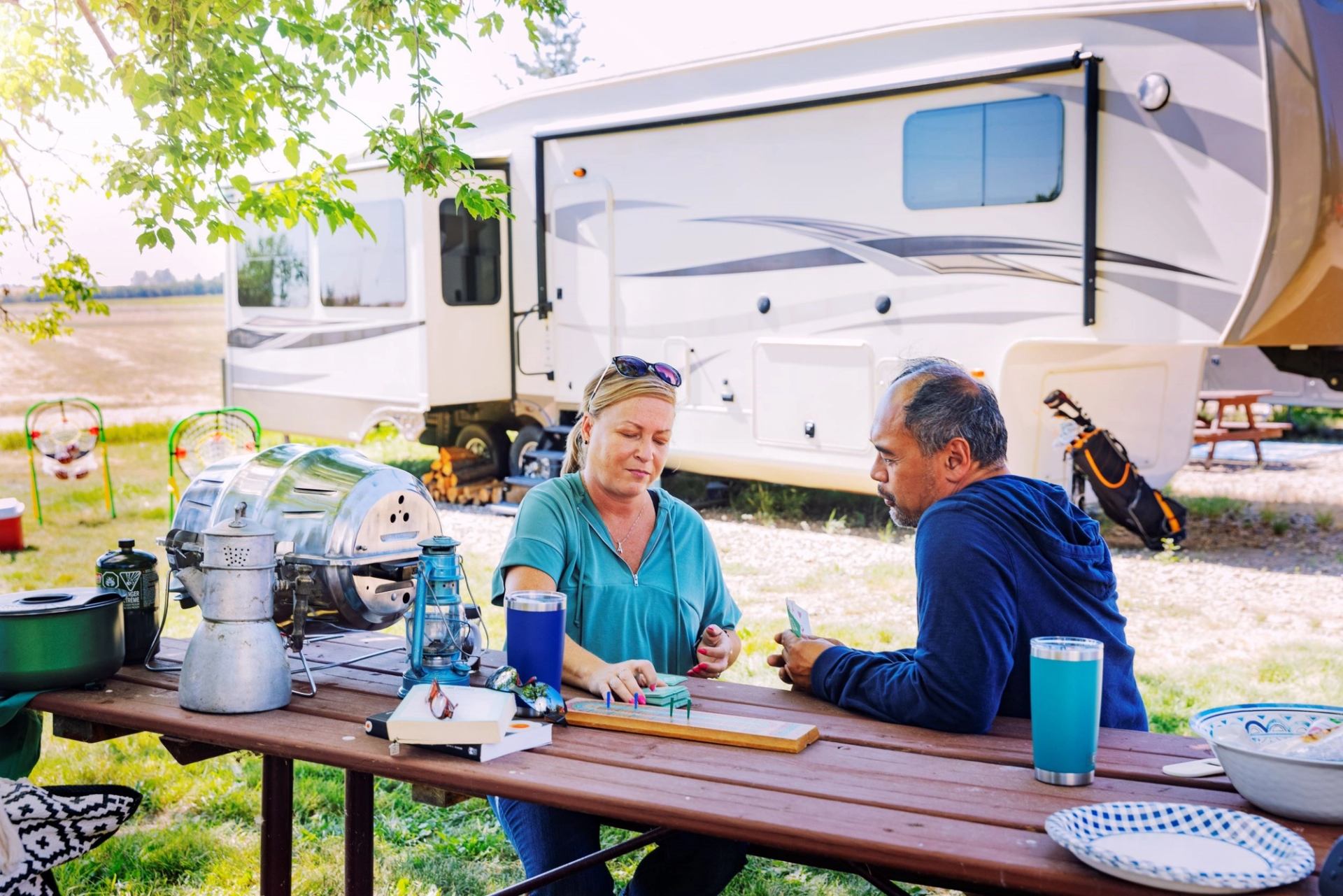A couple sat to a picnic take in the campground