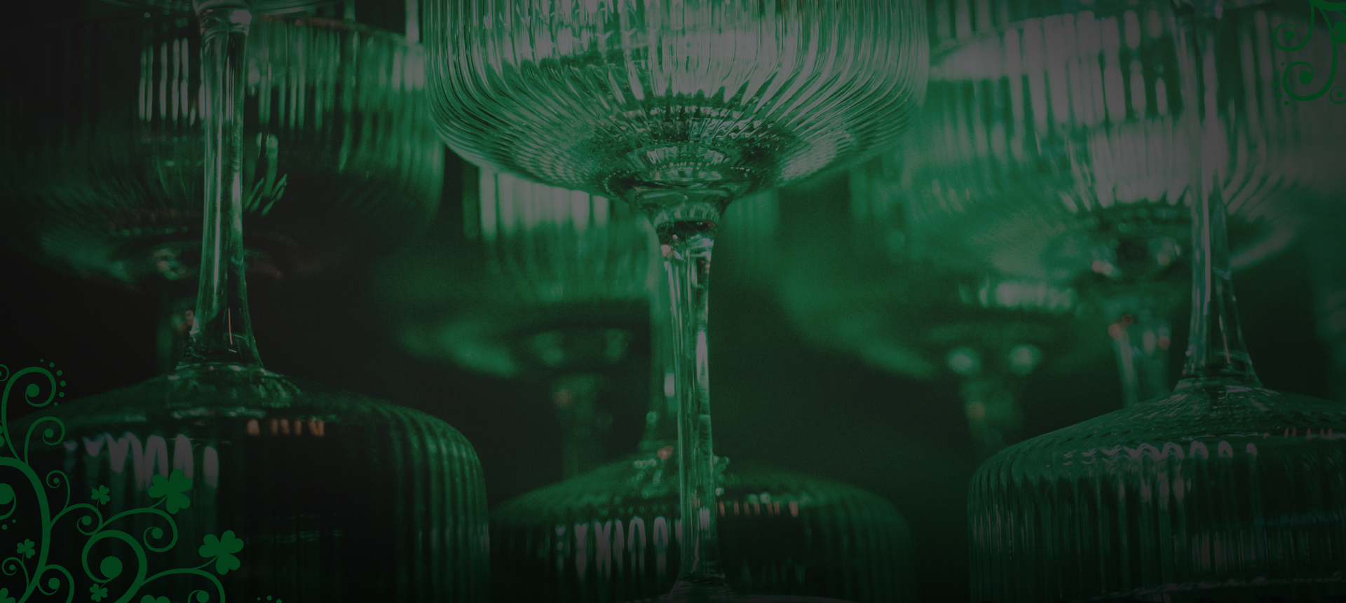 Green-lit bar scene with elegant cocktail glasses and St. Patrick’s Day décor creating a festive atmosphere.