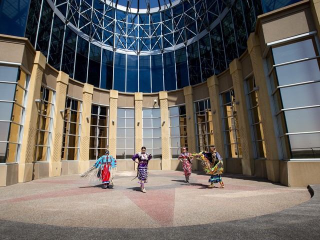 Siksika Blackfoot dancers in front of the Blackfoot Crossing Historical Park Interpretive Centre.