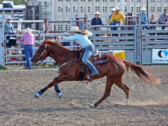 A lady racing her horse.