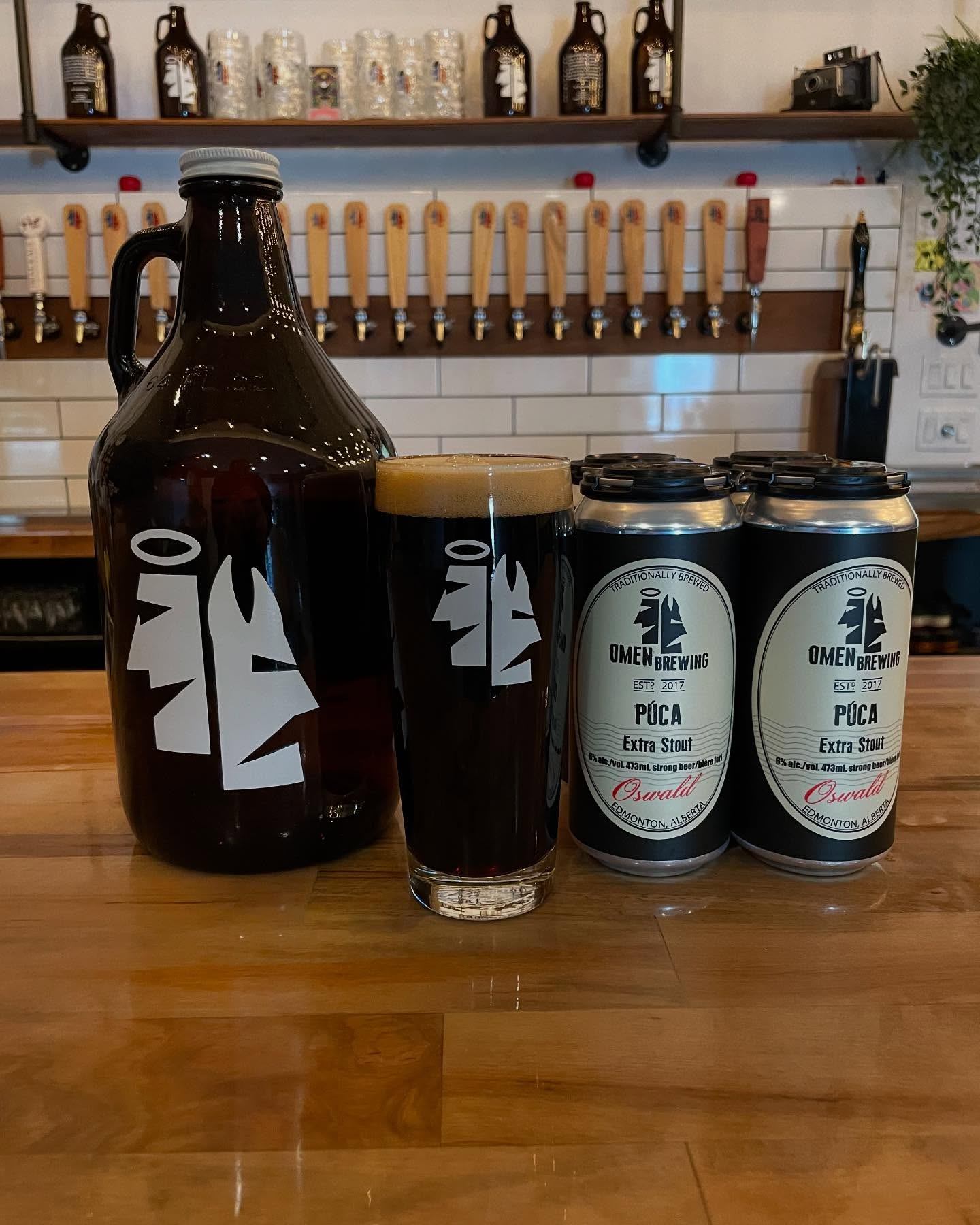 Growler, pint, and cans of Púca Extra Stout on the Omen Brewing bar