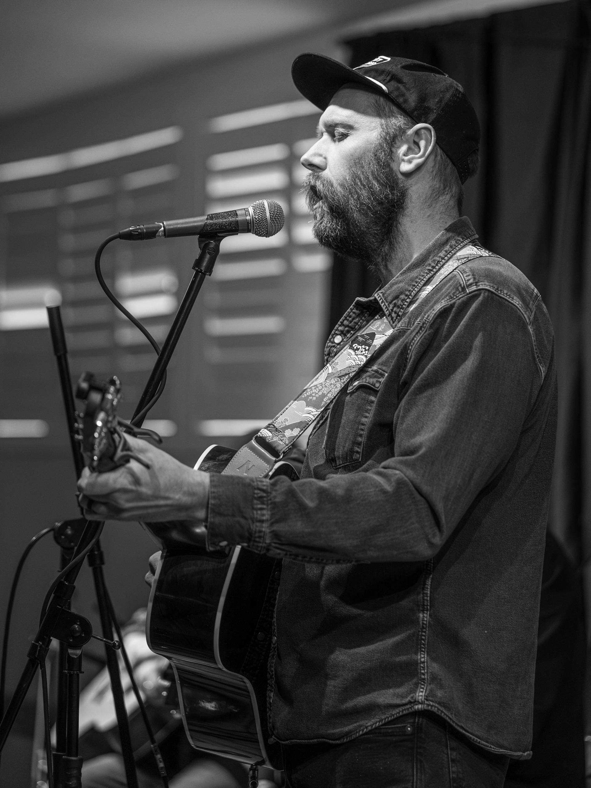 Music in the Badlands captures a close-up acoustic performance at a microphone.