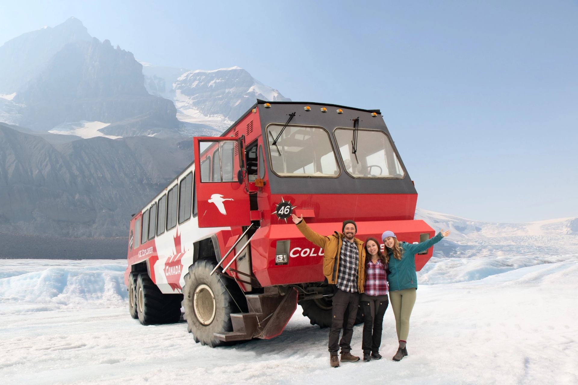 Three people stood in from of the Ice Explorer