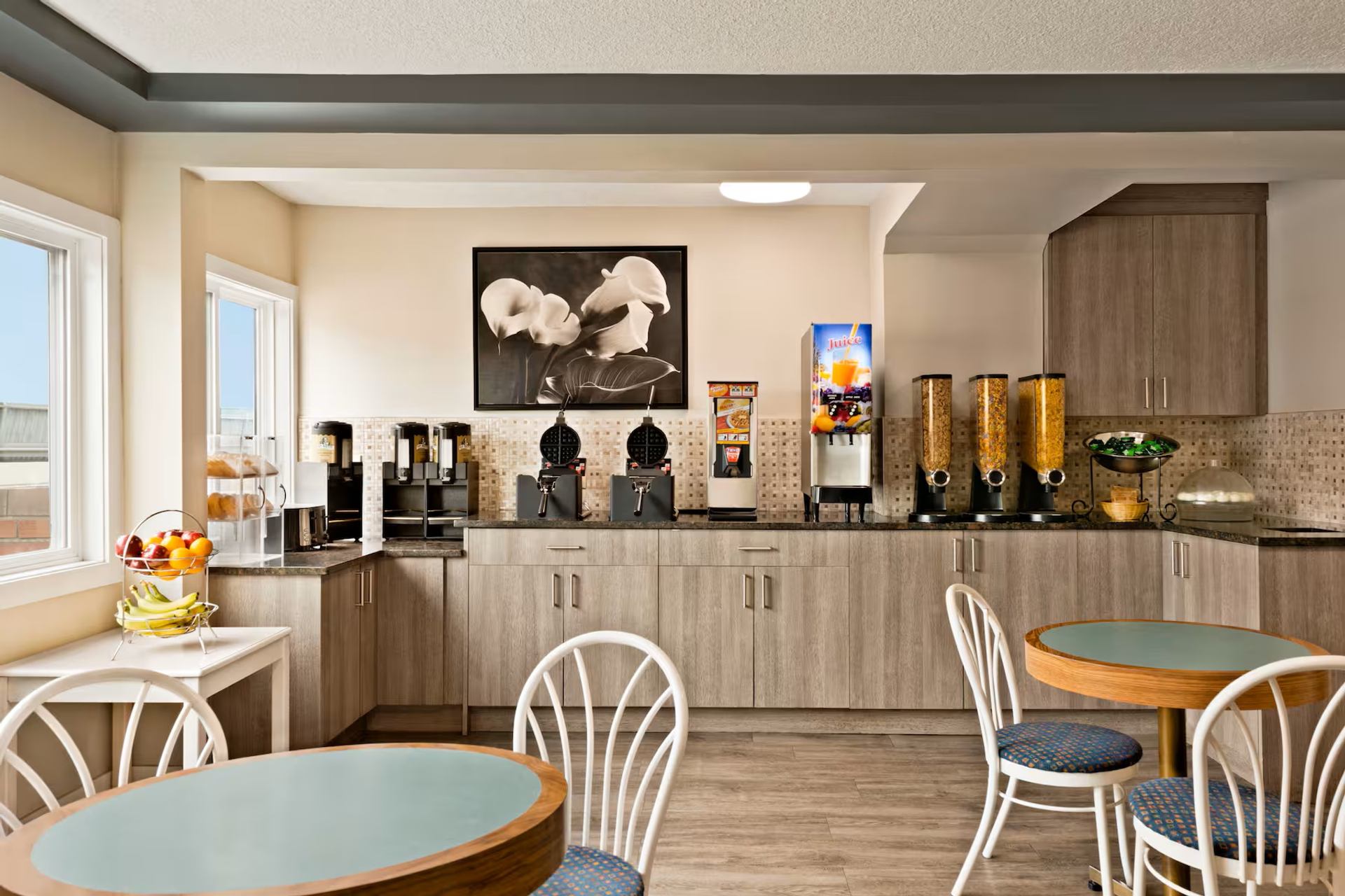 Travelodge Calgary South offers a bright breakfast area with coffee, juice, cereal, and seating.