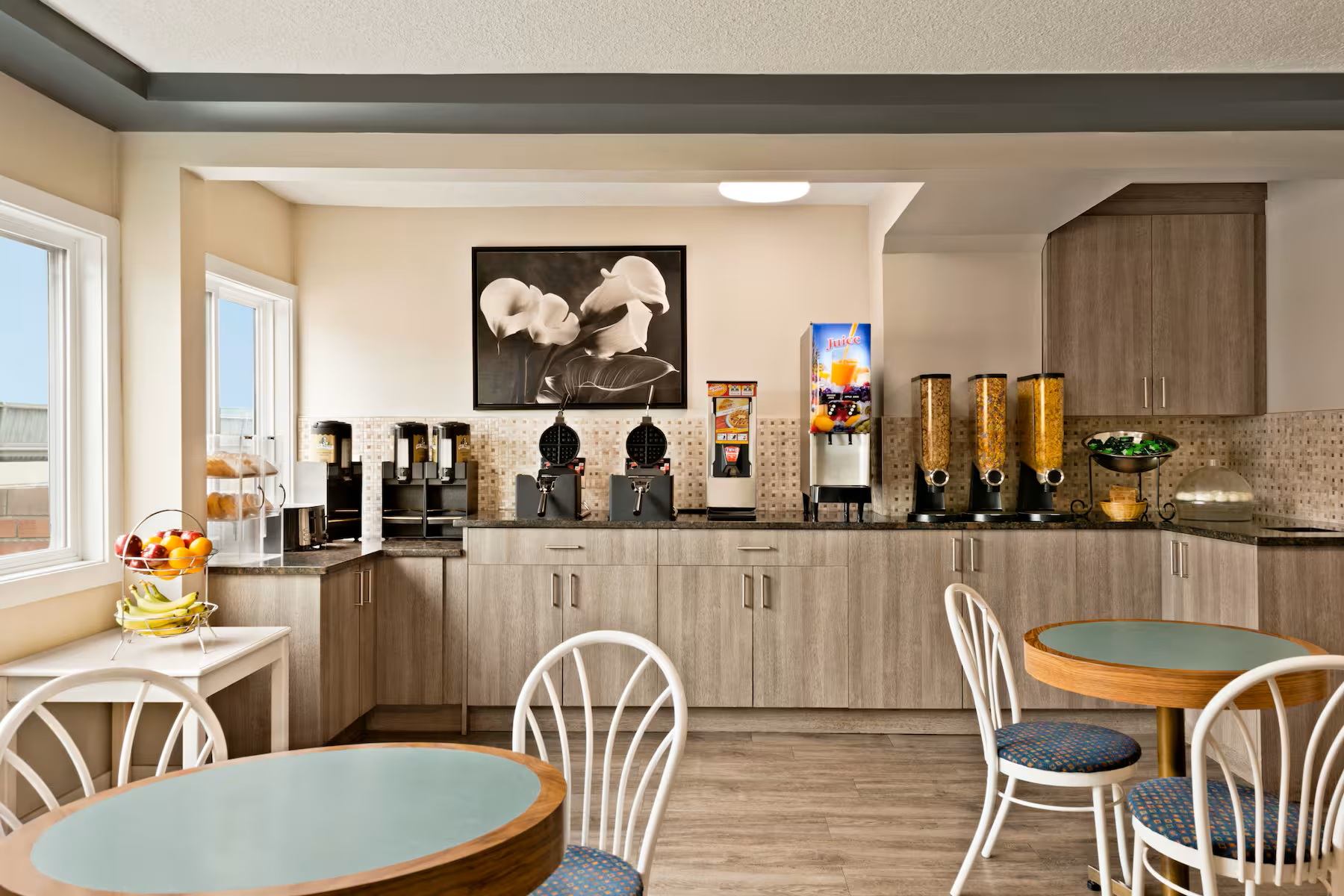 Travelodge Calgary South offers a bright breakfast area with coffee, juice, cereal, and seating.