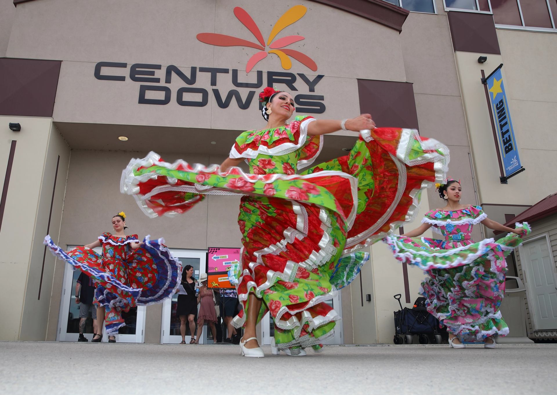 Traditional dancers in vibrant dresses performing at Century Downs