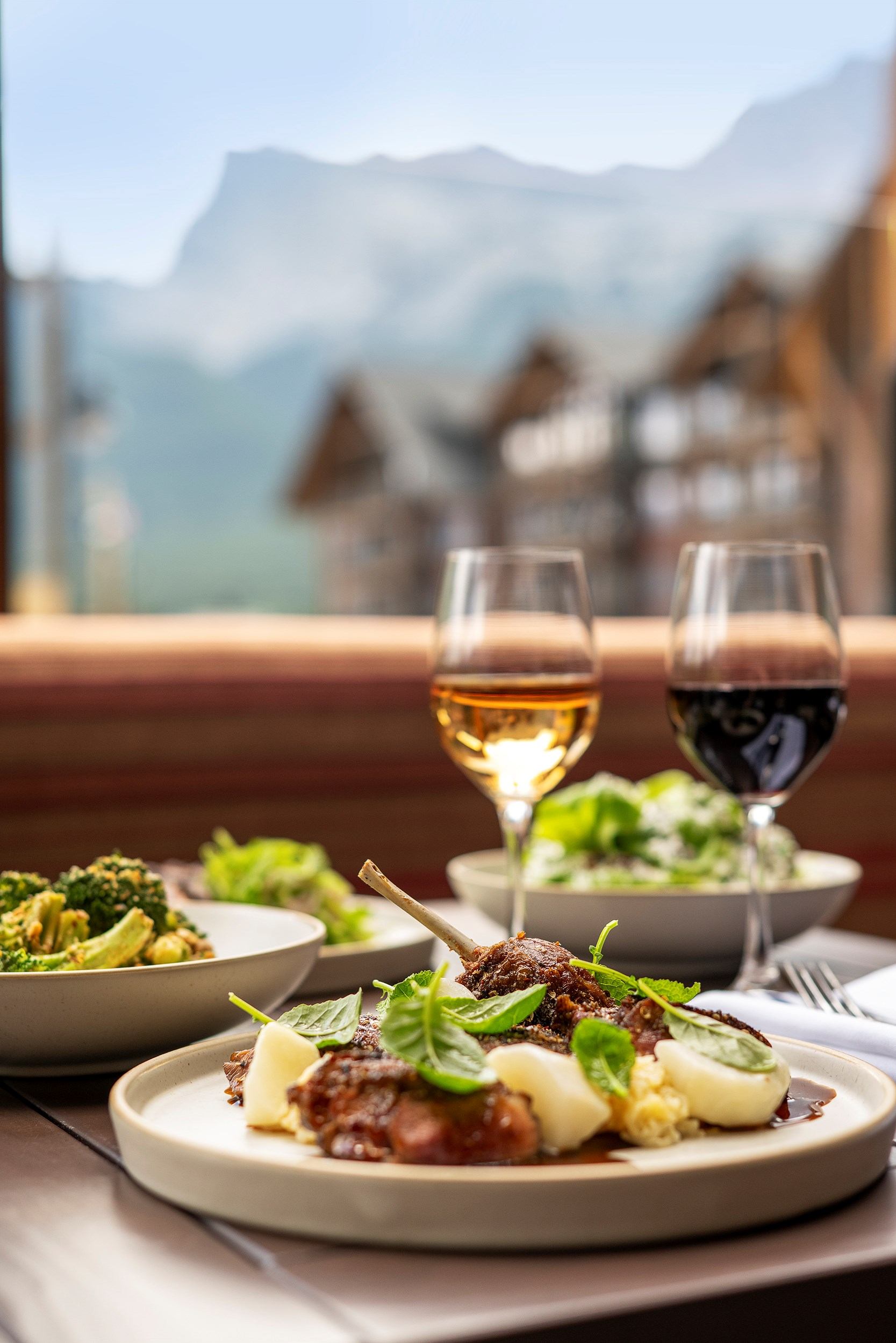 A meal with wine with the Rockie Mountains in the background