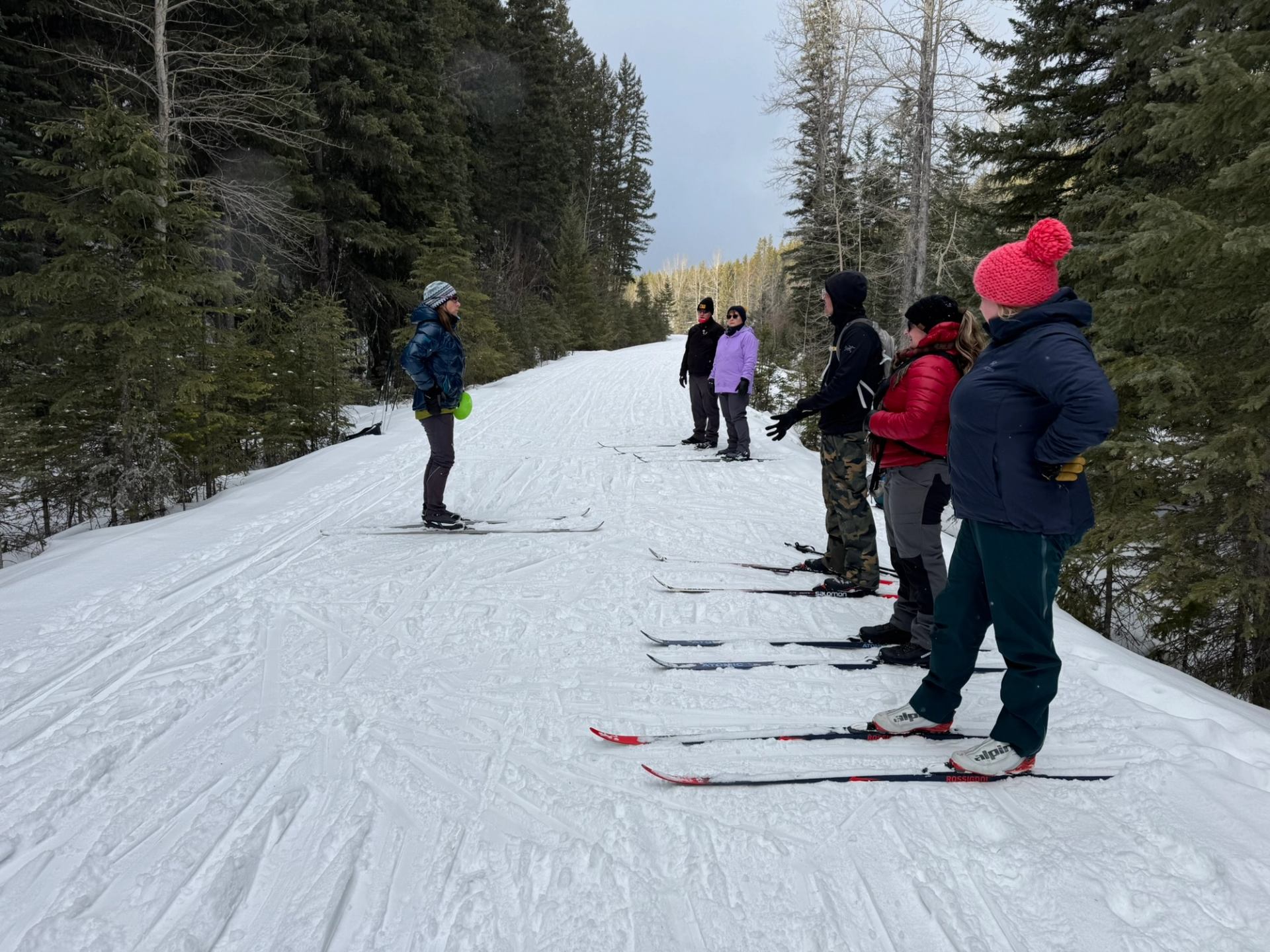 A cross-country ski coach teaching a lesson.