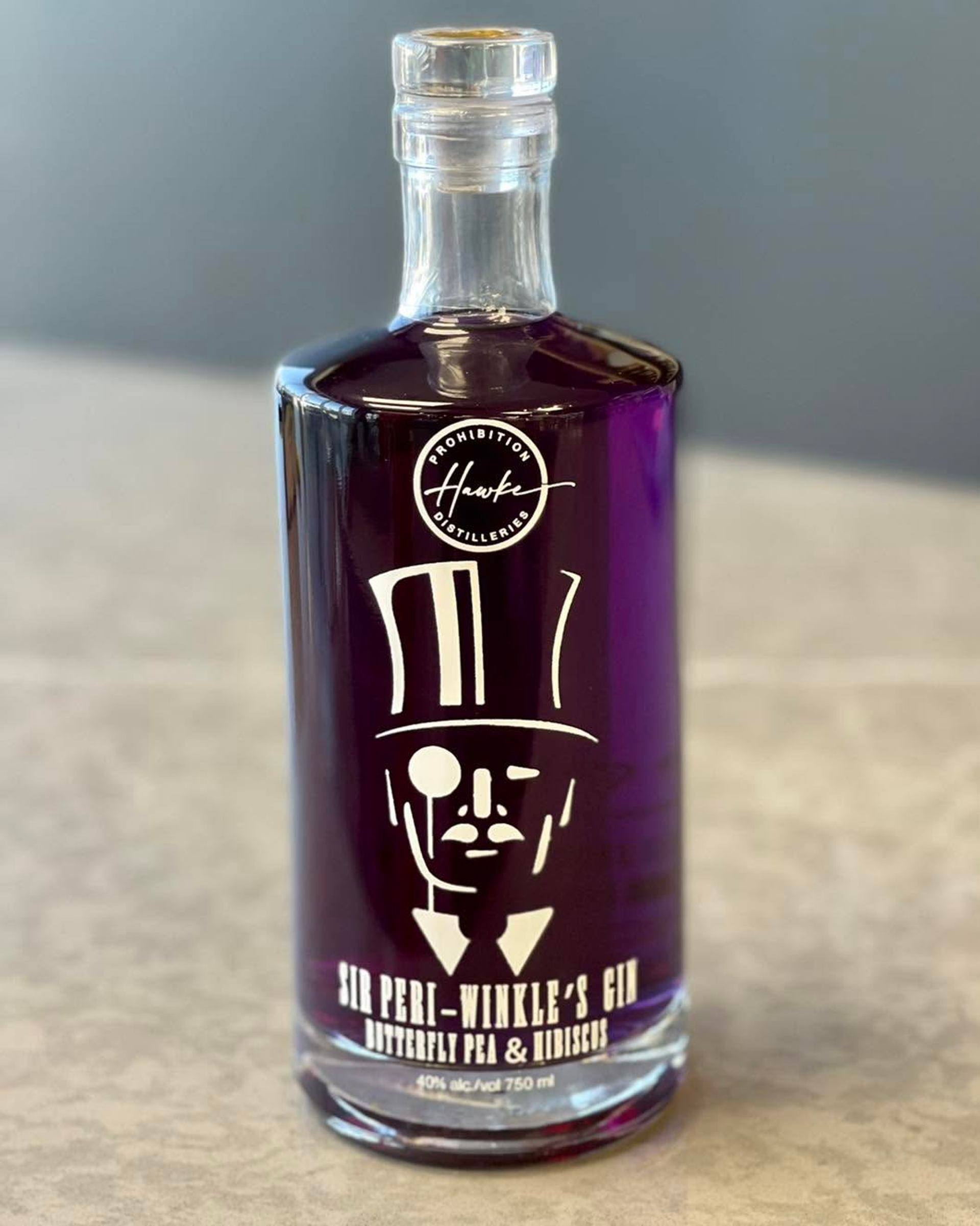 Purple Sir Peri-Winkle’s Gin bottle from Prohibition Hawk Distilleries on a countertop.