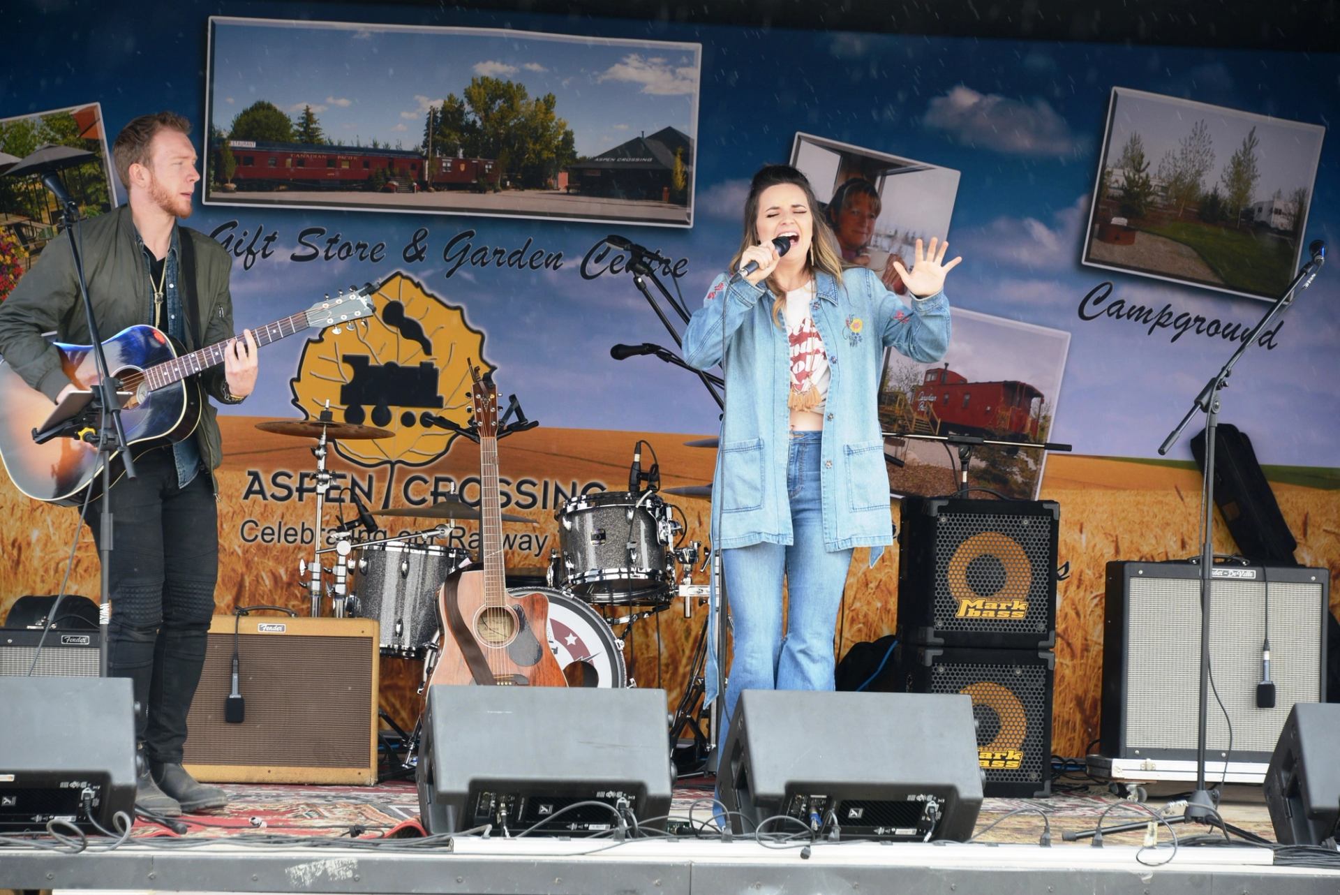 Live concert stage at Aspen Crossing with singer, guitar player, and speakers during Southern Albert.