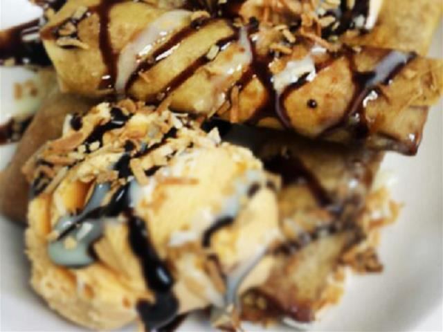 Fried rolls with chocolate sauce, ice cream, and toasted coconut flakes.