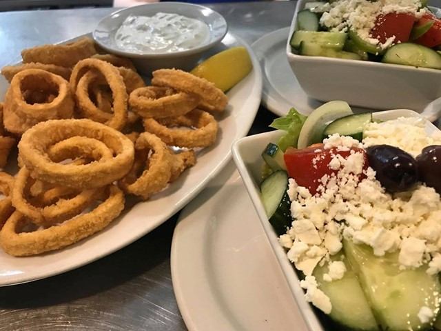 Crispy calamari rings with tzatziki and a fresh Greek salad topped with feta.