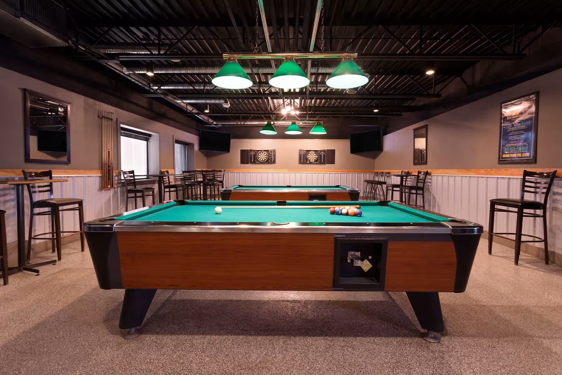 Bar with two tables and green lights.