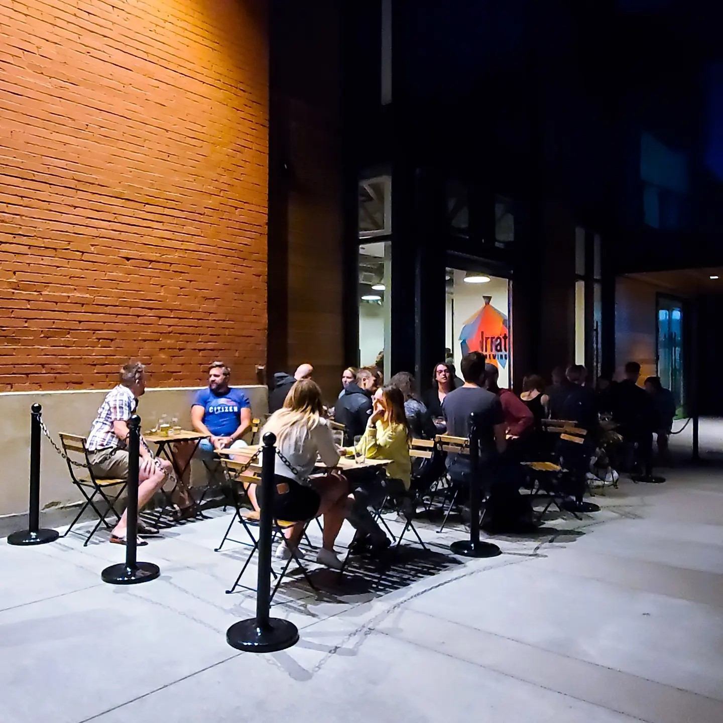 The patio at the brewing company with a group of people enjoying brews.