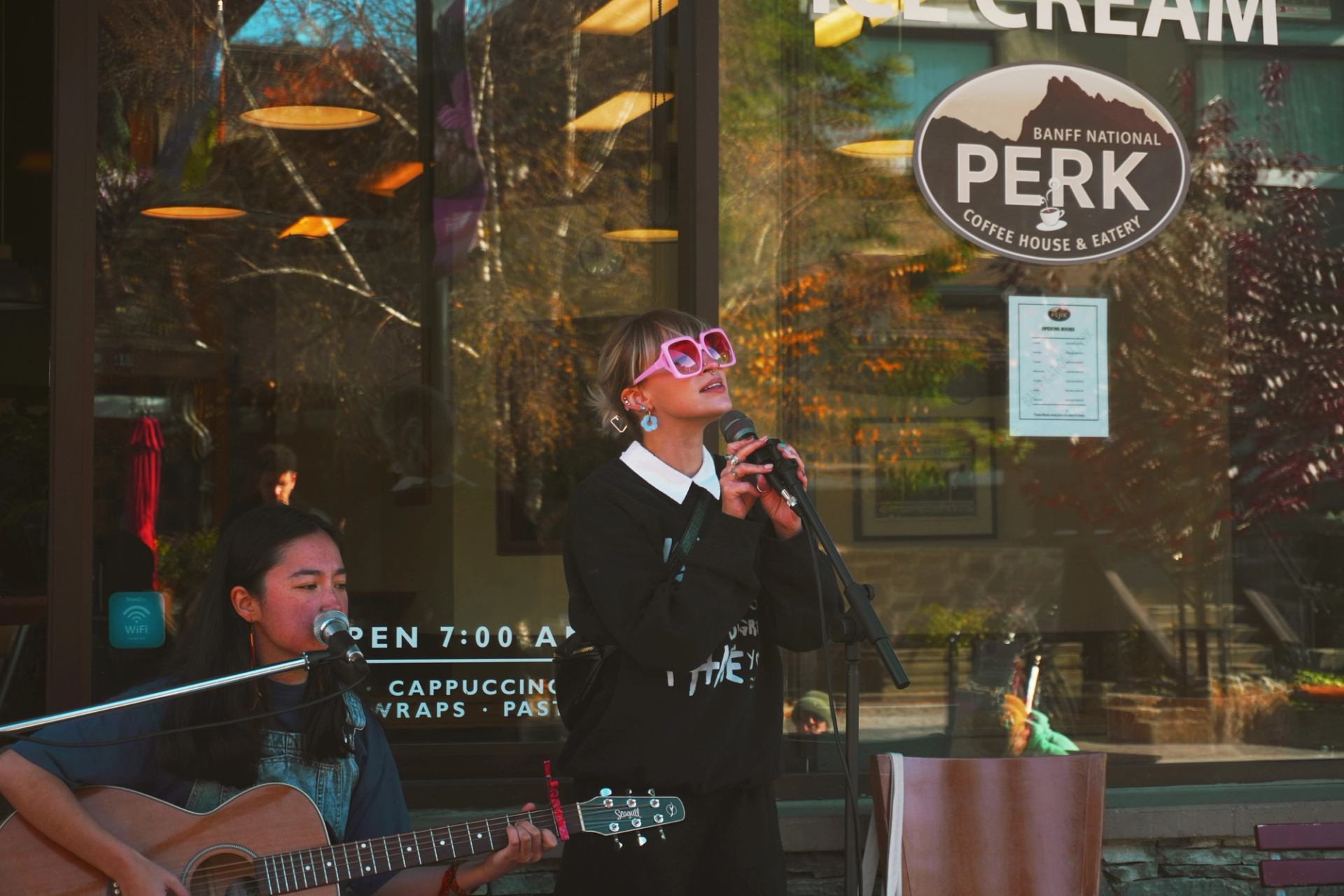 Two peformers playing music outside Perk
