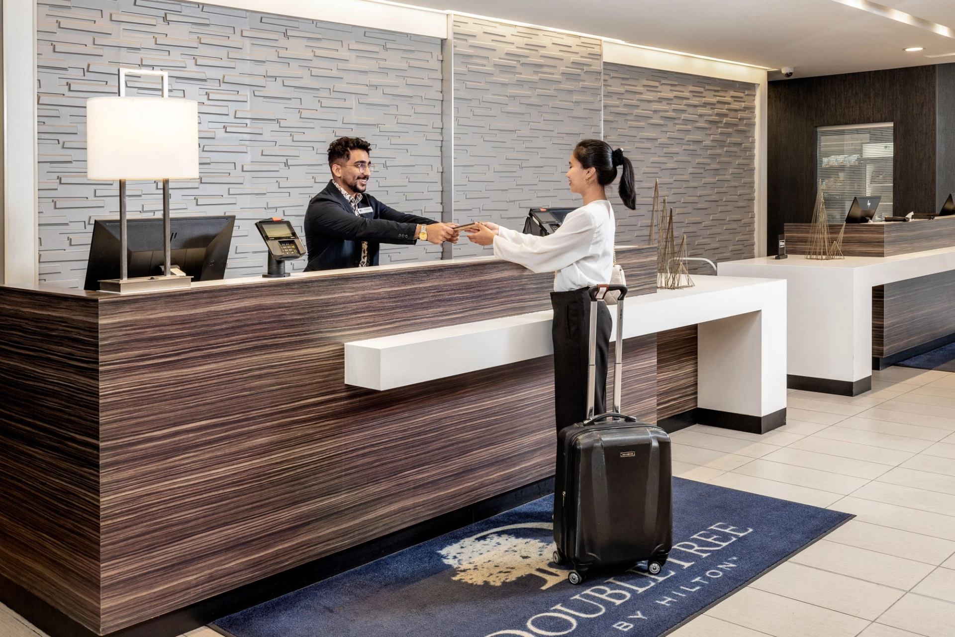 A woman checking in at the front counter