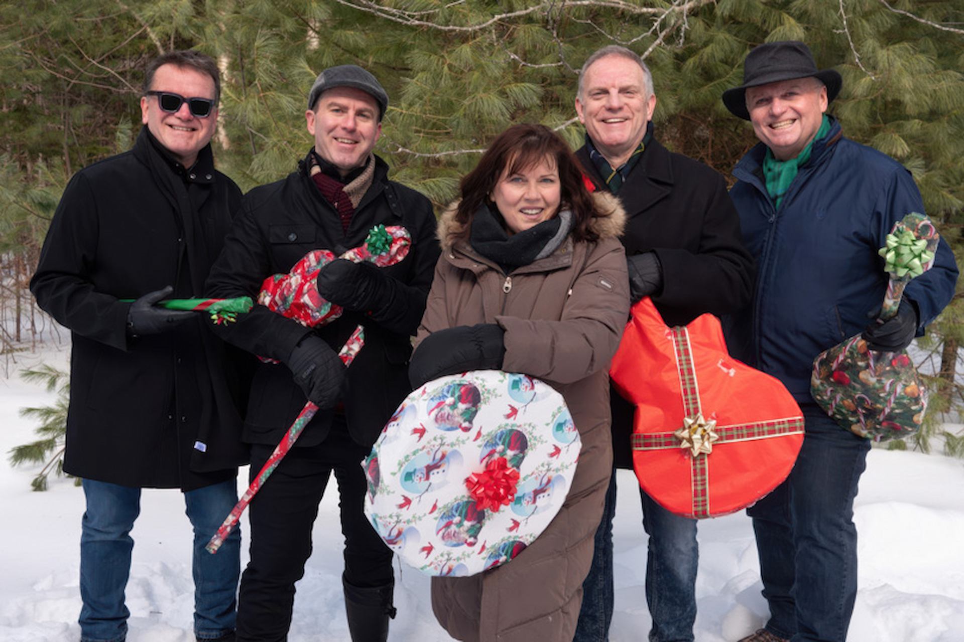 The Barra MacNeils with wrapped instruments in snowy forest for East Coast Christmas.
