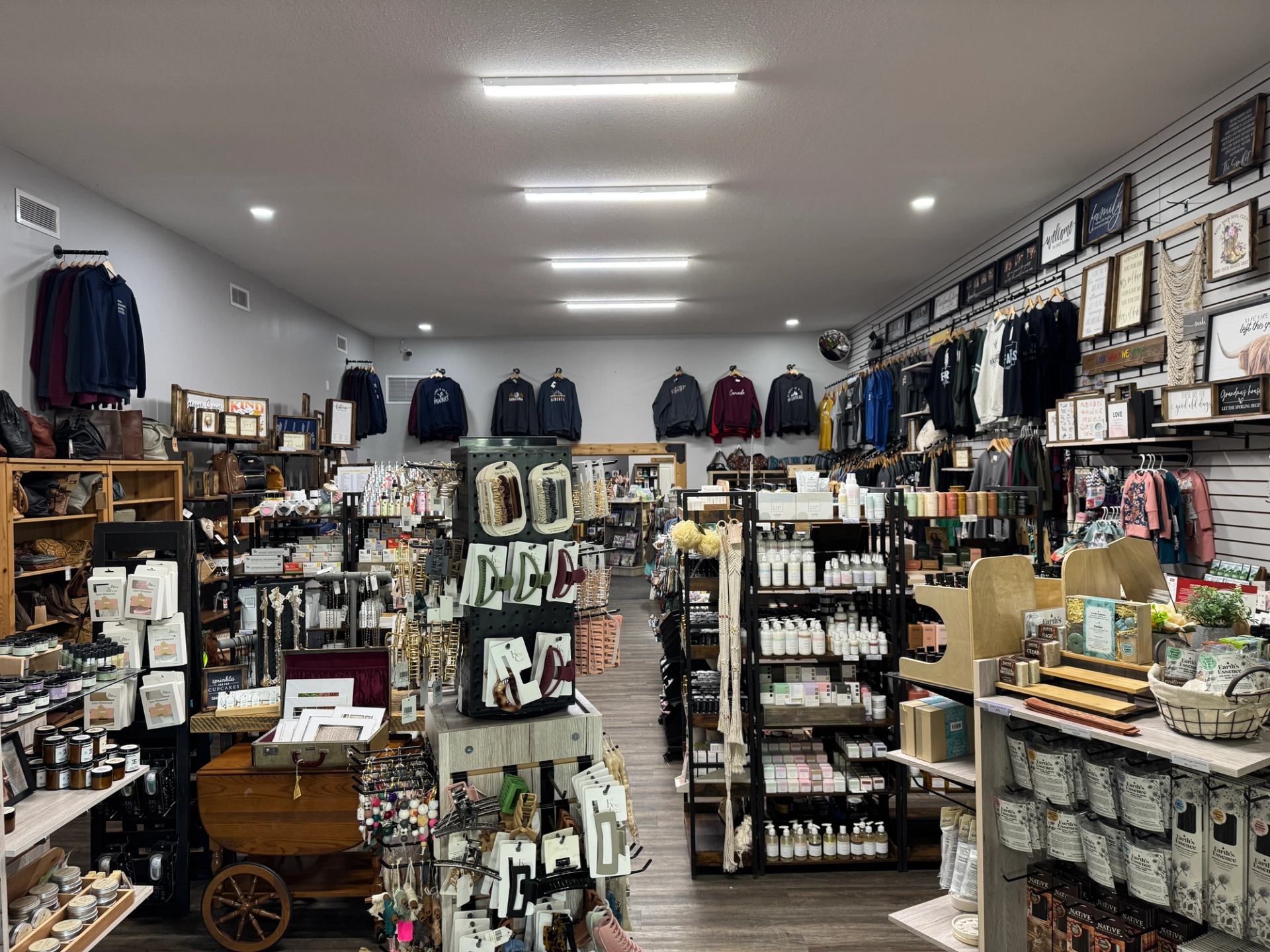 Interior of Farmstead Market & More with shelves of clothing, decor, and personal care items.