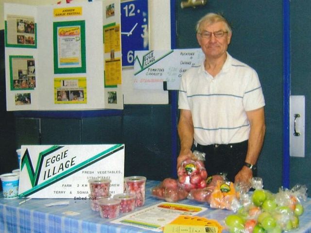 Table of fresh produce at Veggie Village booth in Andrew Farmers' Market.