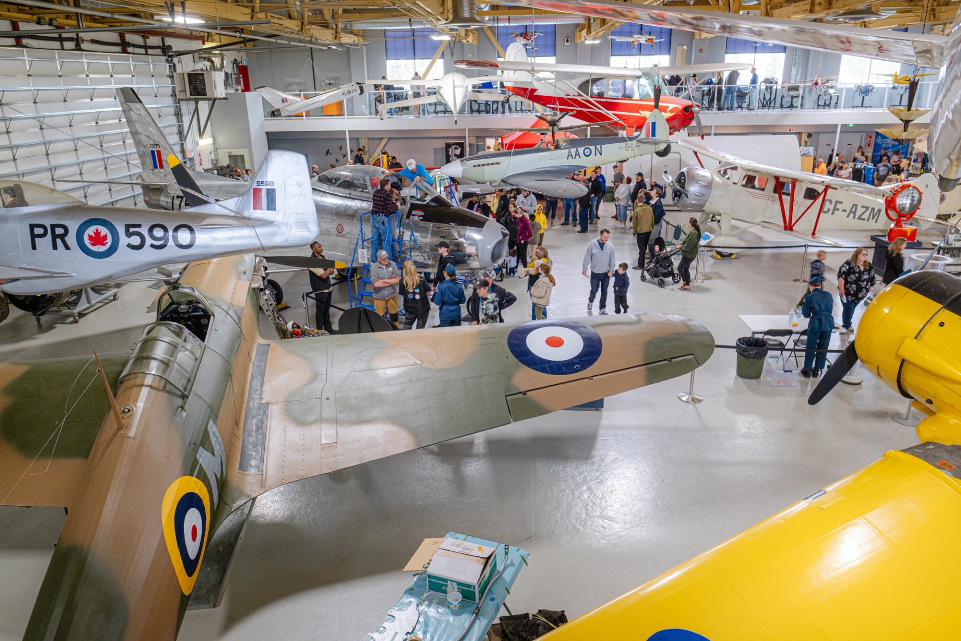 Crowds enjoying historic aircraft displays inside The Hangar Flight Museum during Family Day.