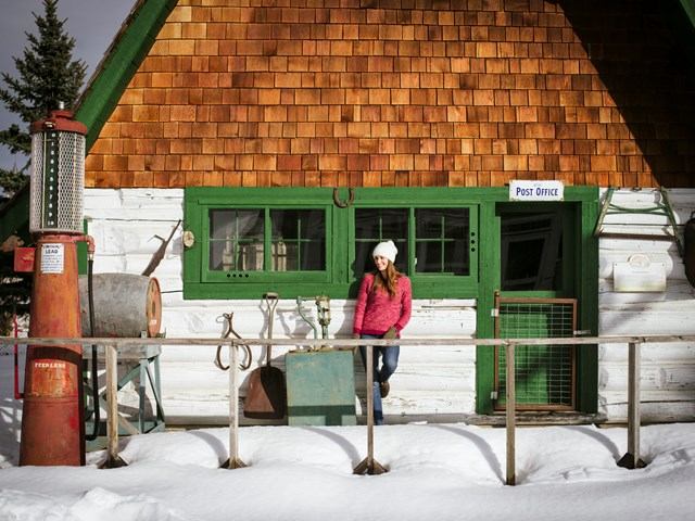 Rustic museum building with antique tools and snow-covered ground.