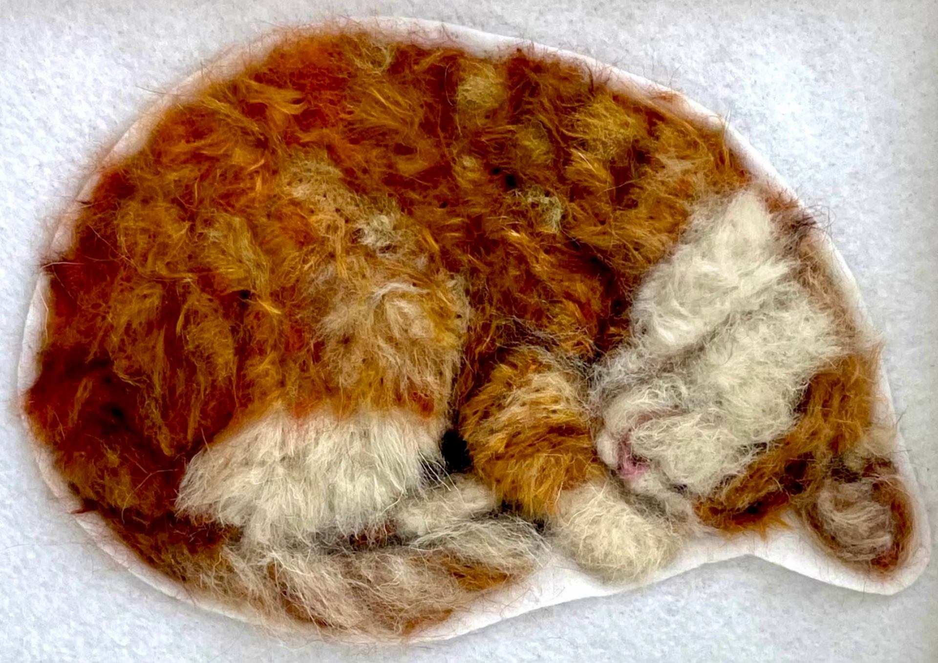 Fiber art piece depicting a cat.