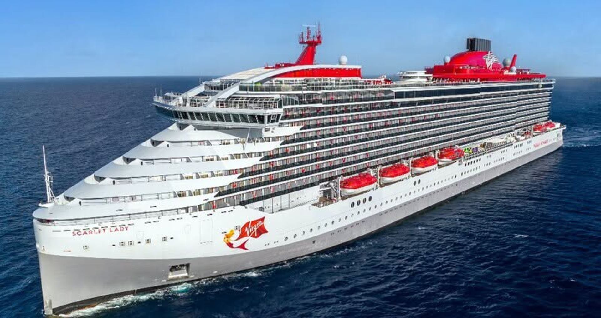 Virgin Voyages Scarlet Lady cruise ship sails across open ocean.