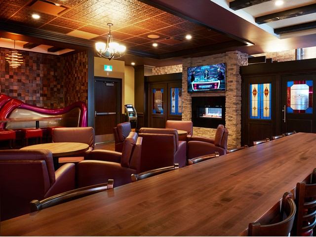 Elegant pub interior with leather seating, fireplace, and wood accents.