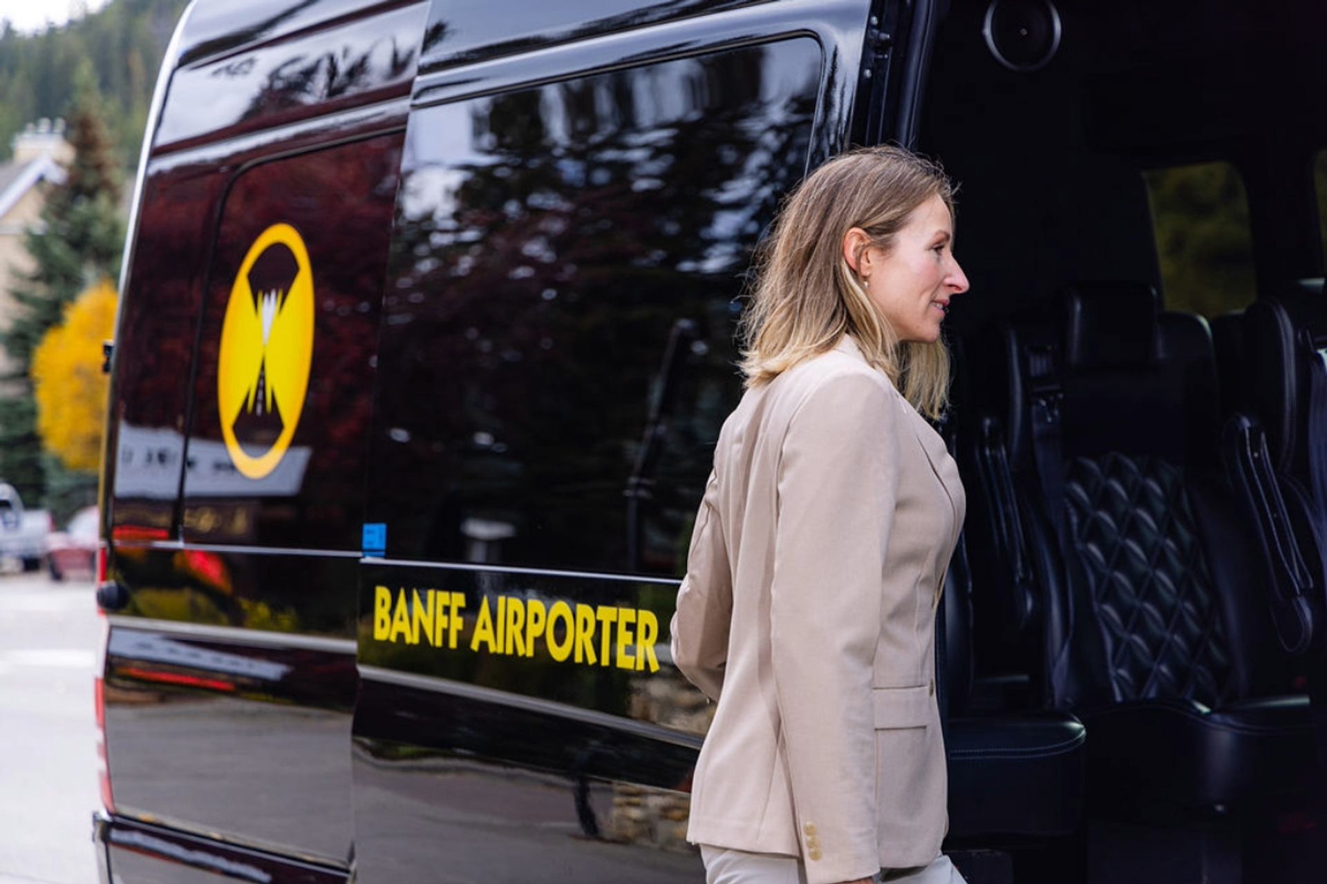 Woman entering Banff Airporter Sprinter Van.