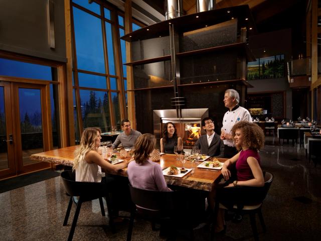 Friends having dinner and chatting with the Chef at Azuridge Estate Hotel in Priddis.