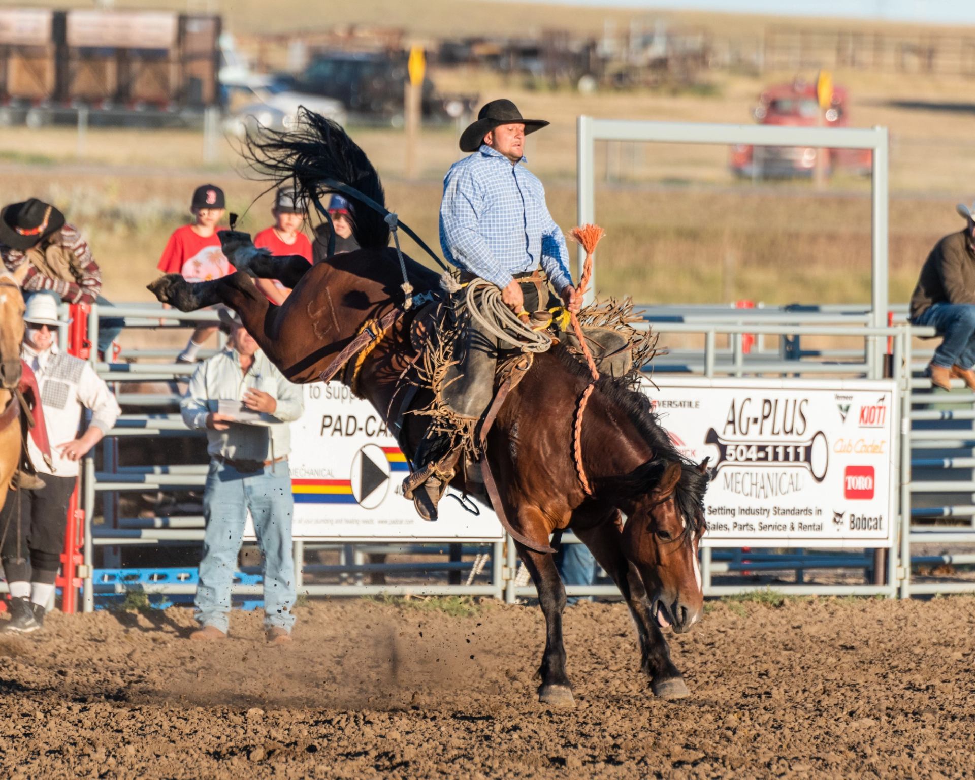 A man riding a broncing horse.