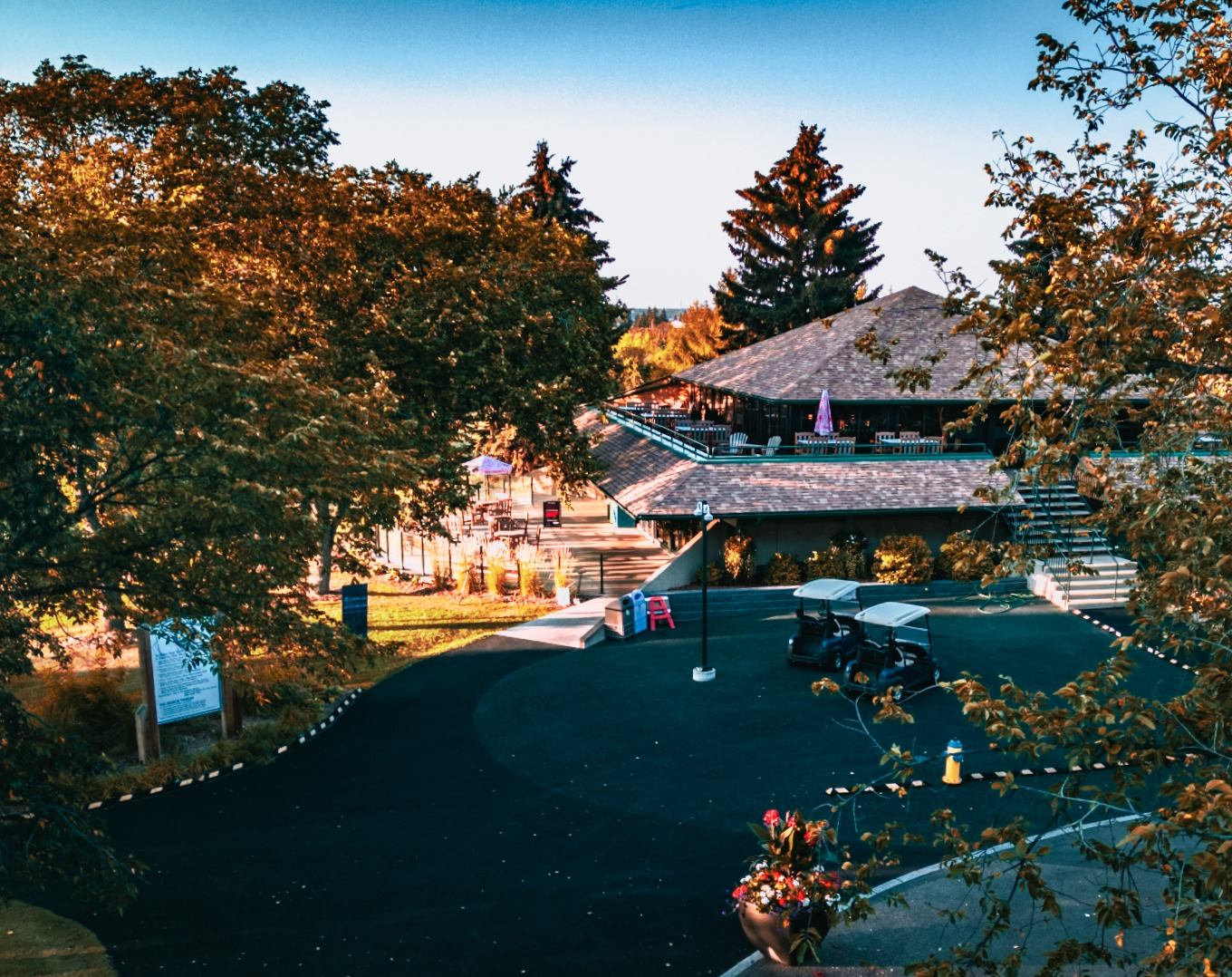 Clubhouse at Rundle Park Golf Course surrounded by trees, golf carts, and fall foliage.
