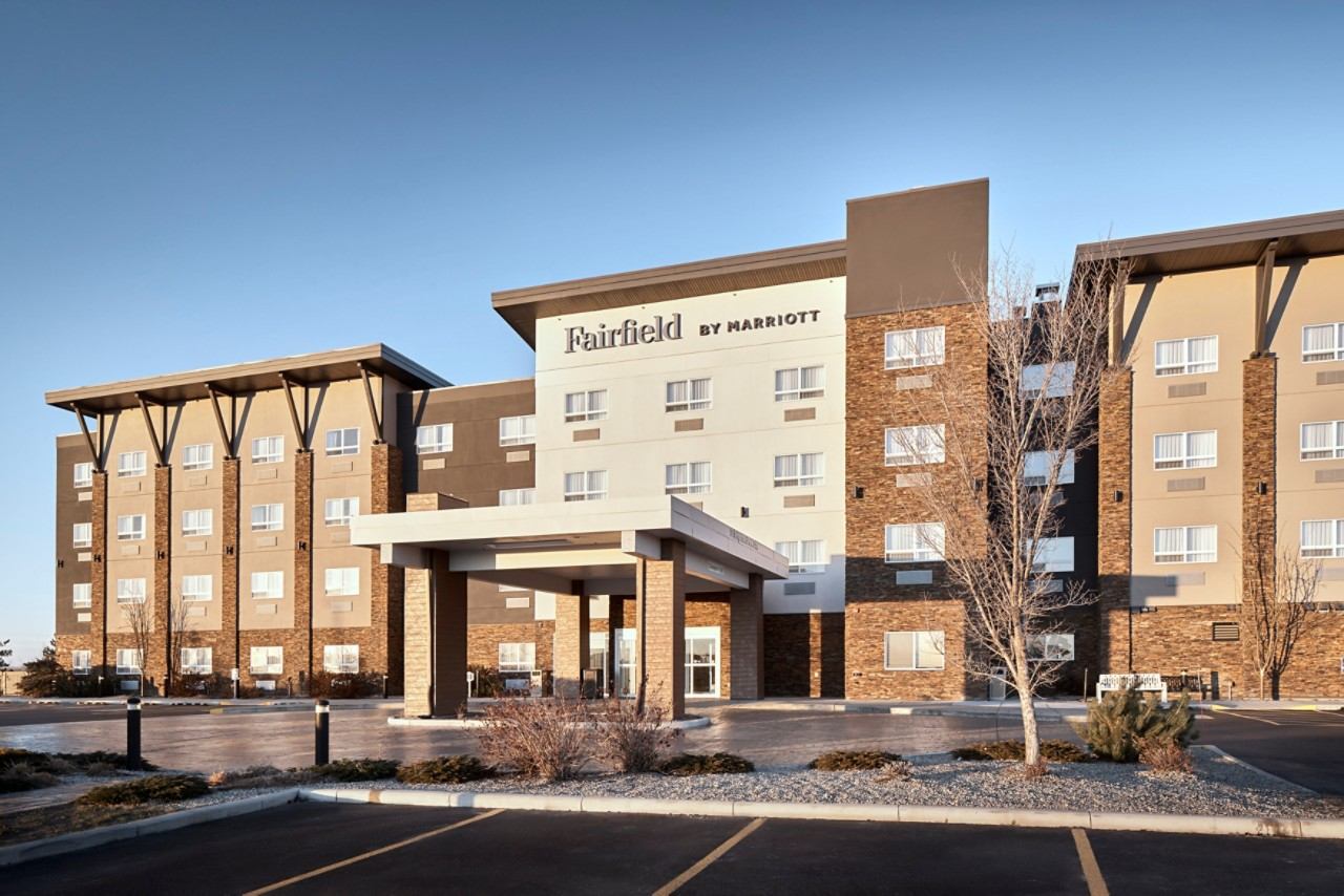 Fairfield by Marriott hotel exterior with covered entrance and empty parking lot.
