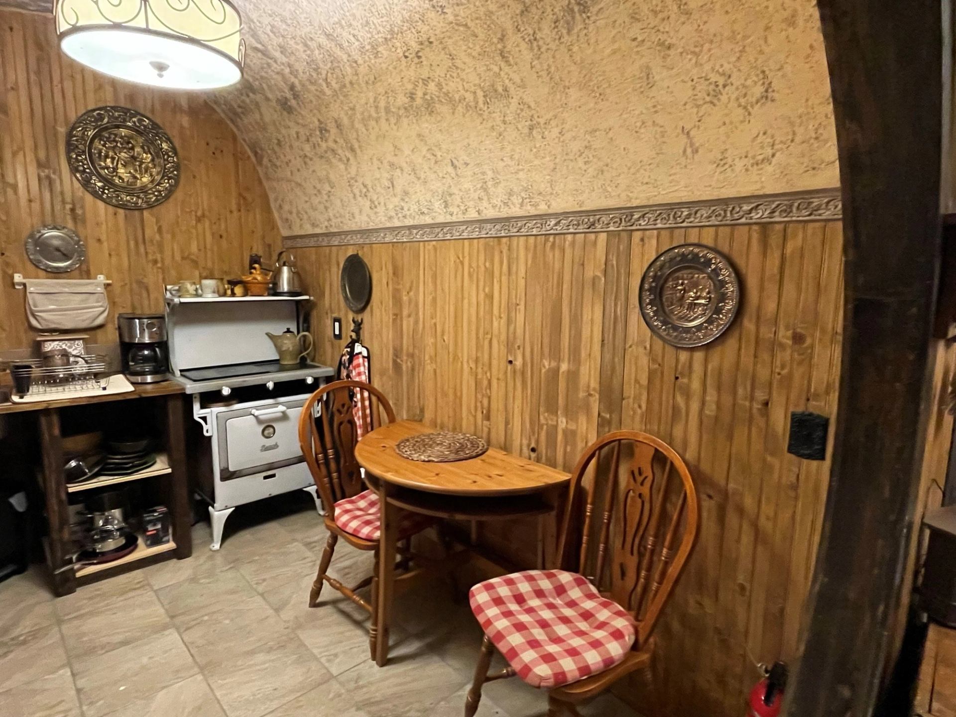 The kitchen at The Burrow at Good Knight with table and stove.