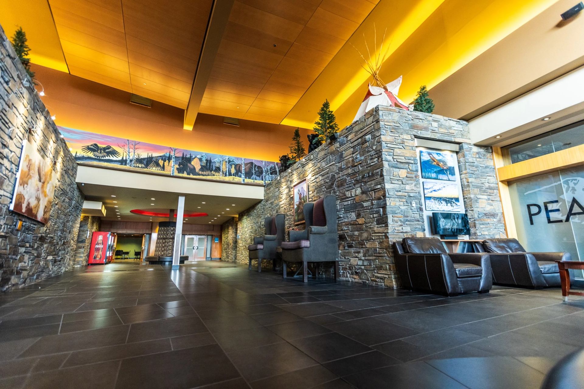 Modern lobby with stone walls and seating.