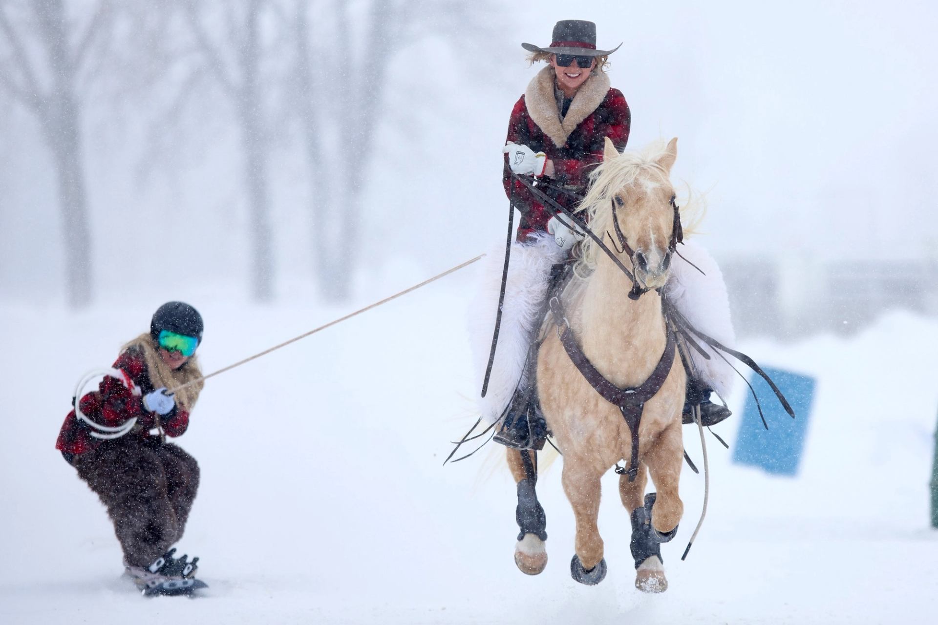 Skier being pulled by a horse through snow during Skijordue festival.