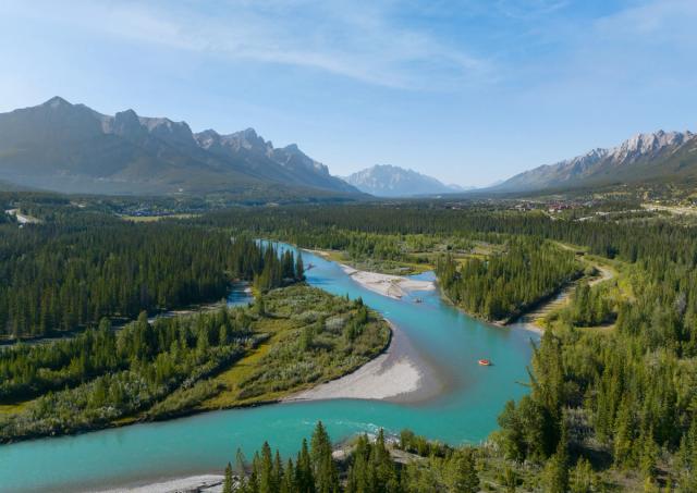 An aerial shot of the Bow Valley and two rafts from Canmore Raft Tours on the Bow River.