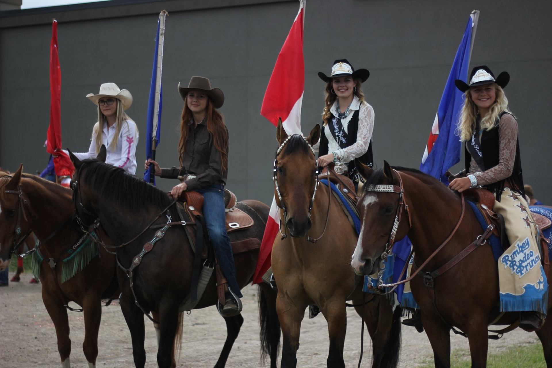 Women on horses holding flags.