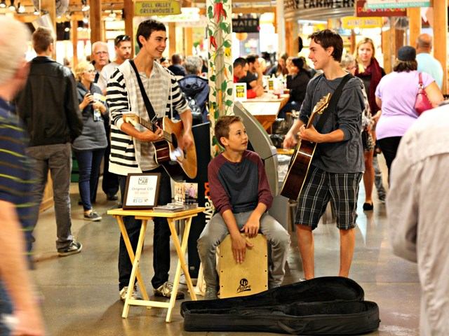 Three young musicians perform for shoppers at Calgary Farmers' Market South