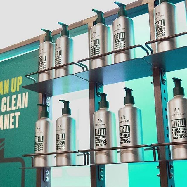 Refill dispensers with pumps and labels on a metal stand, inside Kingsway Mall.