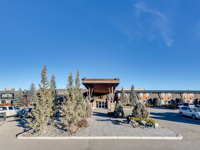 Front view of Seasons Cafe & Eatery with landscaped entrance and clear blue sky.
