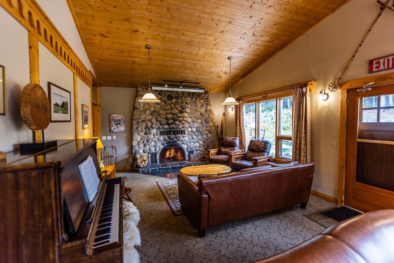 Stone fireplace with leather seating and wooden décor in a lodge lounge