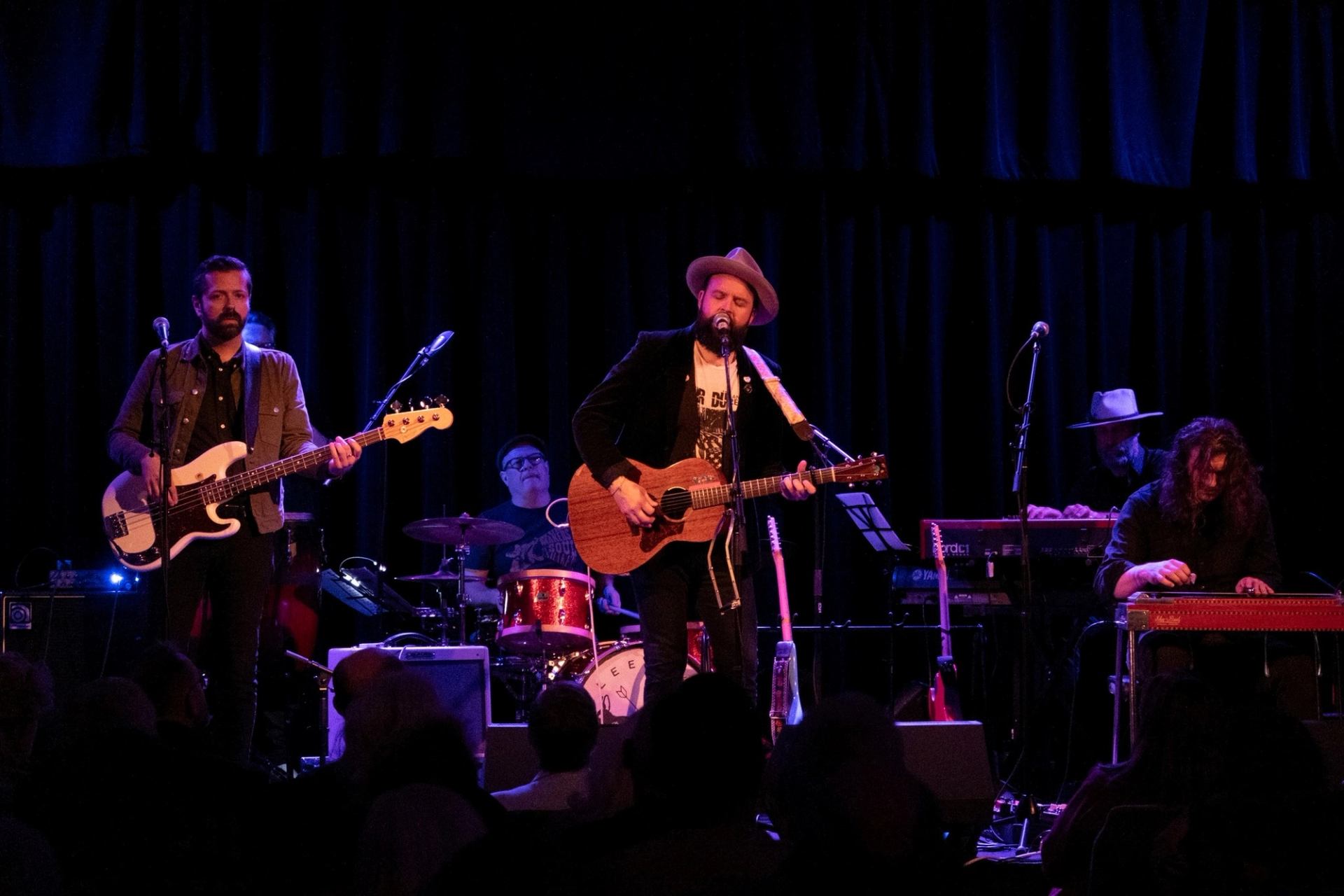 Band performing on stage with guitars and drums at Block Heater festival.