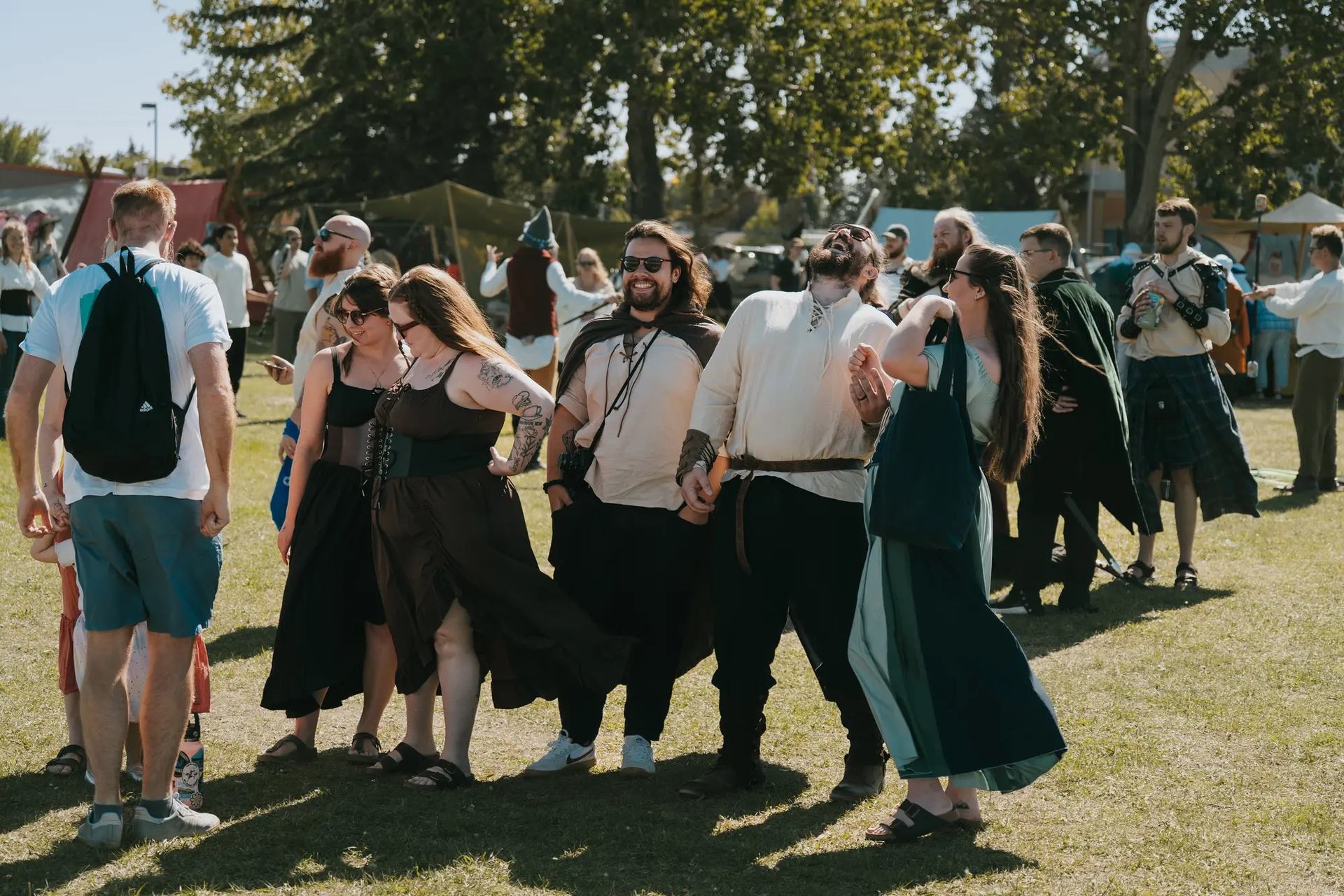 Crowd in themed attire enjoying outdoor festivities at Vegreville Medieval Faire.